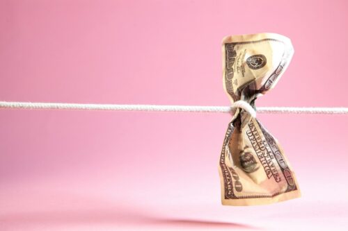 Dollar bill tied in a knot on a string.